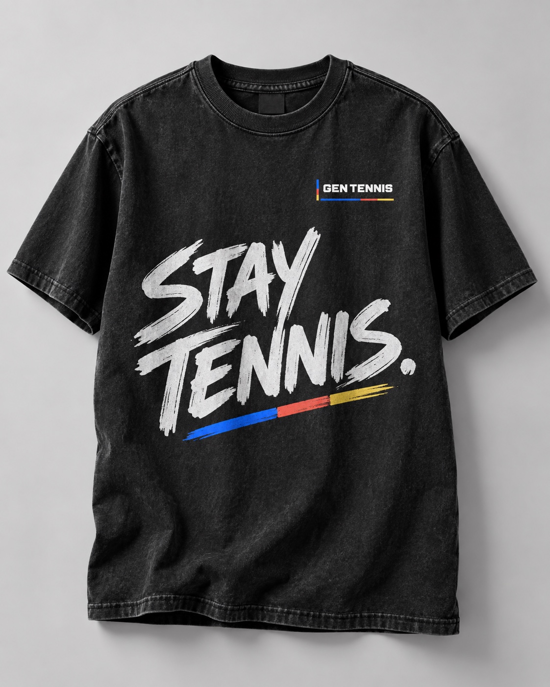 Washed-black T-shirt concept with brush-lettered Stay Tennis statement and blue, red and yellow accents